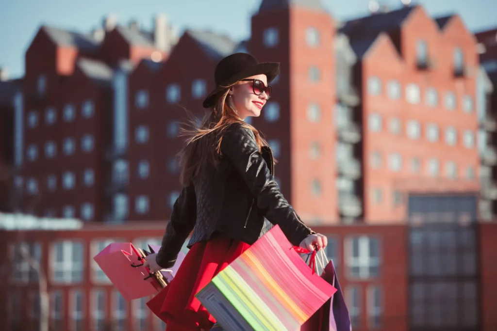 sms_fulfillment_blog_german_marketgirl-walking-with-shopping-bags-city-streets-sunny-day